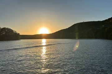 a body of water with a mountain in the background